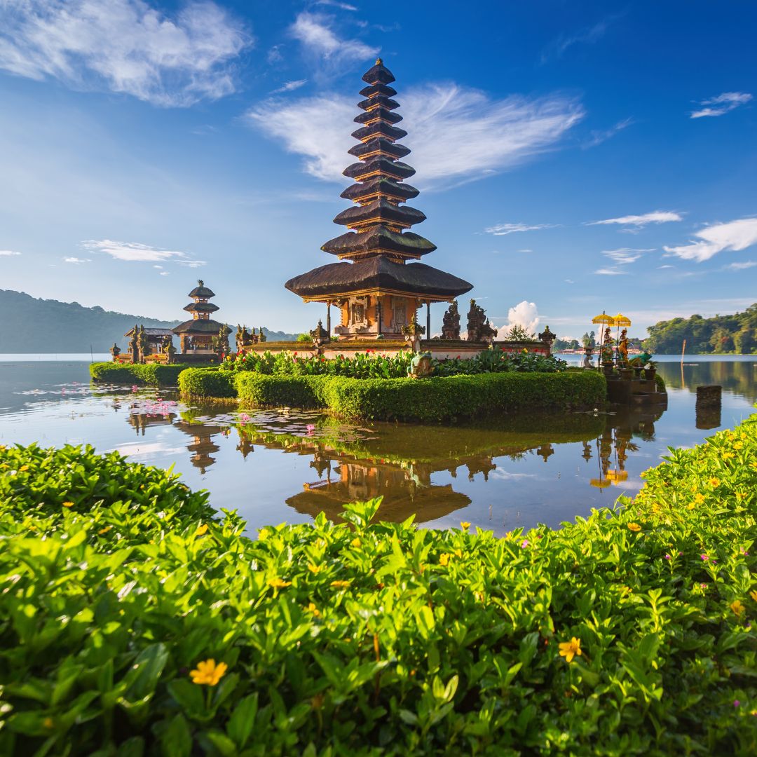 A clifftop resort overlooking the ocean in Bali at dusk, with tropical greenery and an infinity pool, one of Asia's leading luxury island destinations for private jet charter.