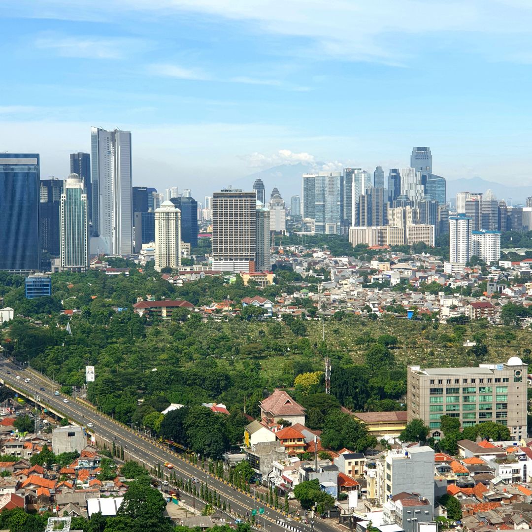The Jakarta skyline at dusk, with the high-rise towers of the central business district, the capital of Indonesia and the largest business hub in Southeast Asia for private jet charter.