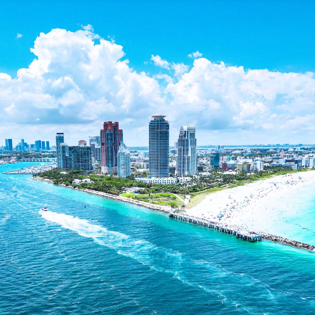 Aerial view of South Beach Miami with turquoise water and high-rise buildings, a trending private jet charter destination.